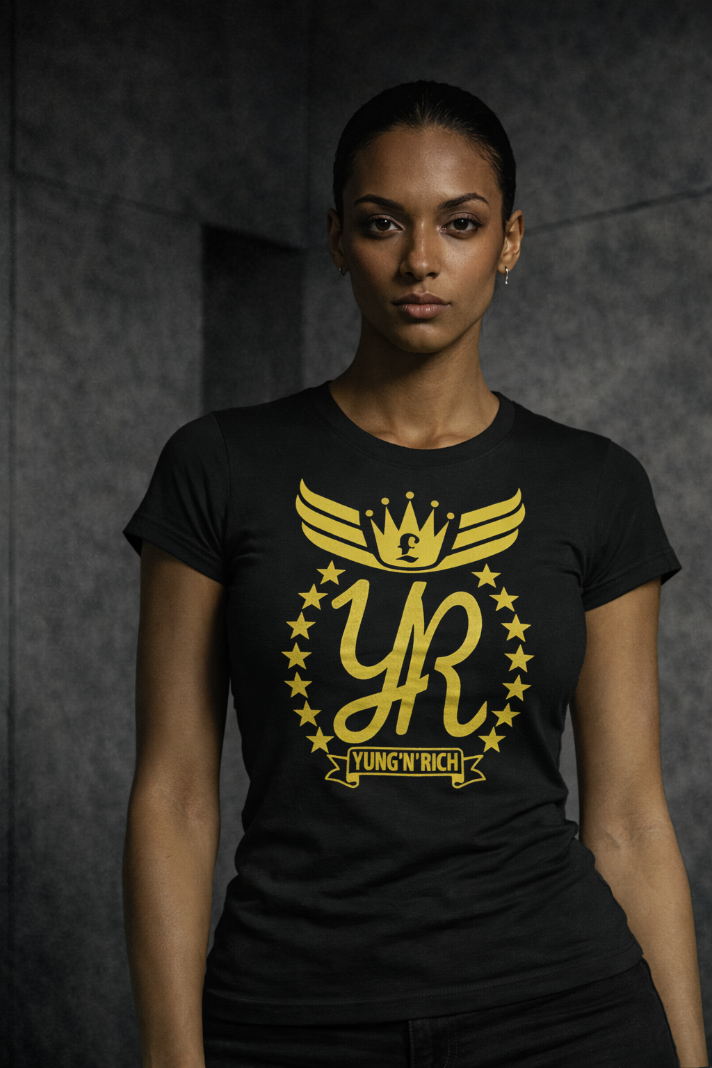 Person wearing a black t-shirt with a yellow logo against a dark background