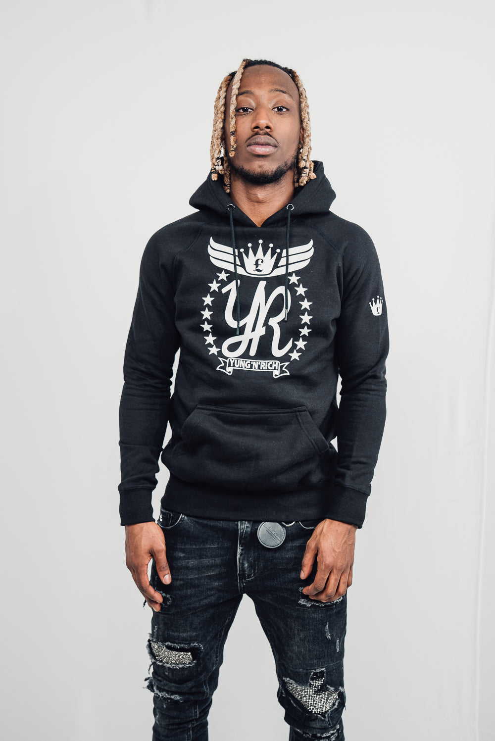 Tizzy Rapper modeling YUNG'N'RICH HOODIE - colour black with white rubber Yungnrich logo side veiw with white rubber Yungnrich crown
