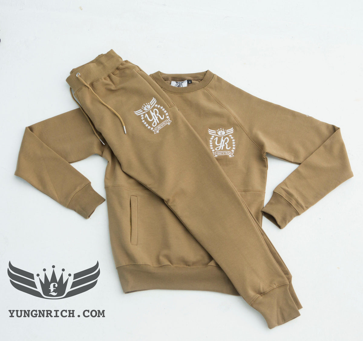 YUNG'N'RICH TRACKSUIT CREW NECK KHAKI SLIMFIT MEN Yungnrich combines sporty looks with sophisticated style successfully bringing a sense of luxury to our recreational wear. Only Available exclusively at Yungnrich, we present our sweatsuit which comes in a Khaki colour way. Features cotton construction, ribbed crew neck & cuffs, tonal Stay luxurious on the go in our full slim fit tracksuit . Yung'n'Rich branding on left of chest & leg.
