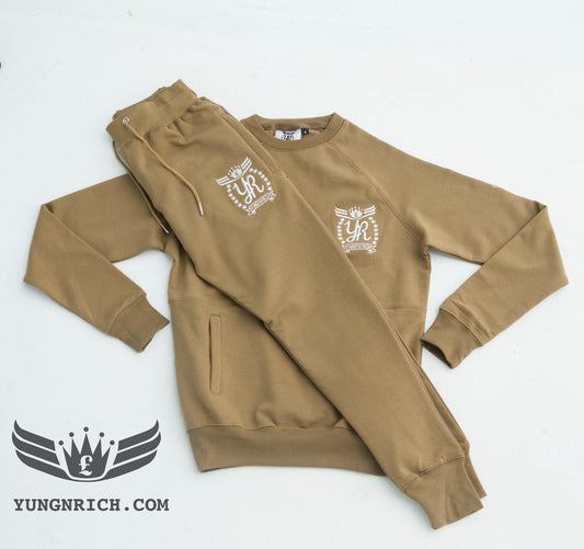 YUNG'N'RICH TRACKSUIT CREW NECK KHAKI SLIMFIT MEN Yungnrich combines sporty looks with sophisticated style successfully bringing a sense of luxury to our recreational wear. Only Available exclusively at Yungnrich, we present our sweatsuit which comes in a Khaki colour way. Features cotton construction, ribbed crew neck & cuffs, tonal Stay luxurious on the go in our full slim fit tracksuit . Yung'n'Rich branding on left of chest & leg.