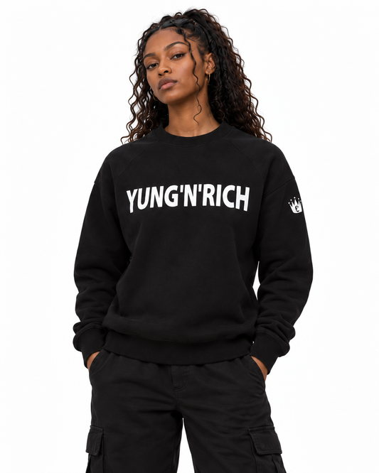 YUNG'N'RICH black women's crewneck jumper on female model, closer front detail view of chest wording and sleeve crown logo