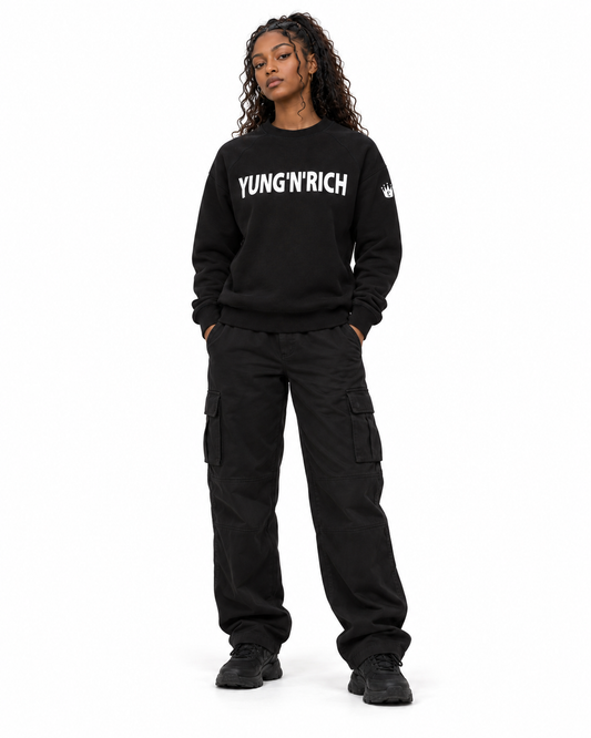 YUNG'N'RICH black women's crewneck jumper on female model, front full-body view