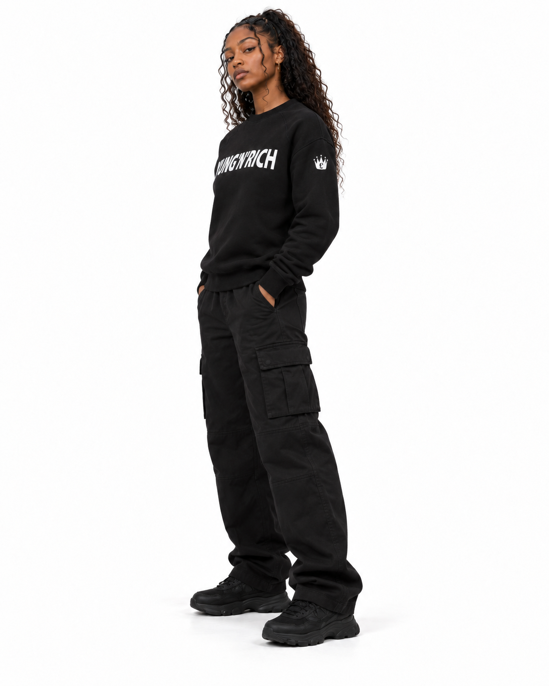 YUNG'N'RICH black women's crewneck jumper on female model, side view showing fit and sleeve crown logo