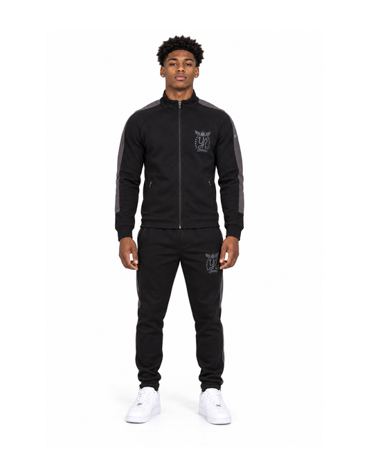 Jaden Brooks wearing the YUNG’N’RICH men’s grey and black tracksuit, straight-on front full-body view.