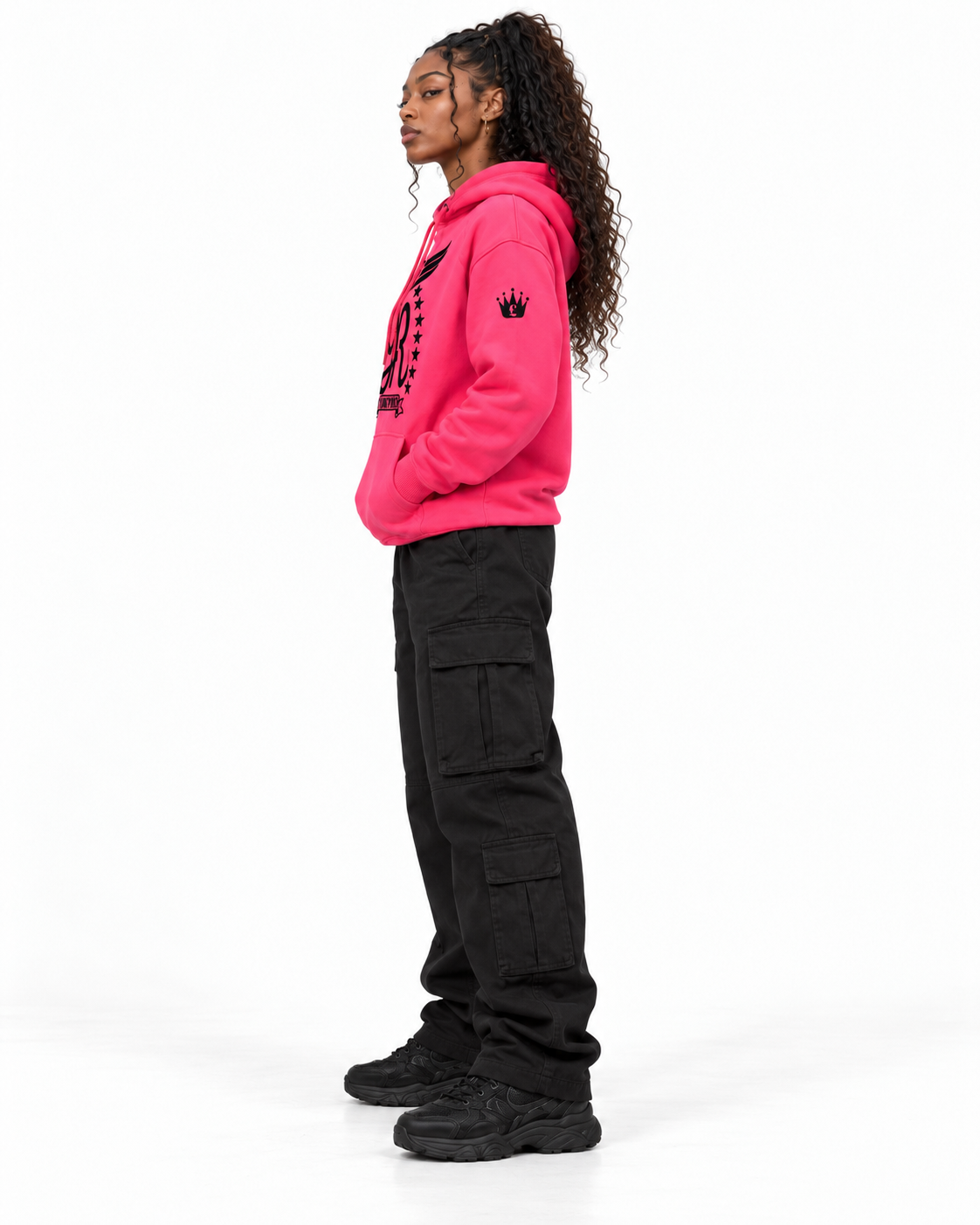 YUNG'N'RICH neon pink women's pullover hoodie on female model, left side profile view