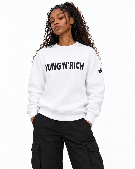 YUNG'N'RICH white women's crewneck jumper on female model, closer front detail view of chest wording and sleeve crown logo