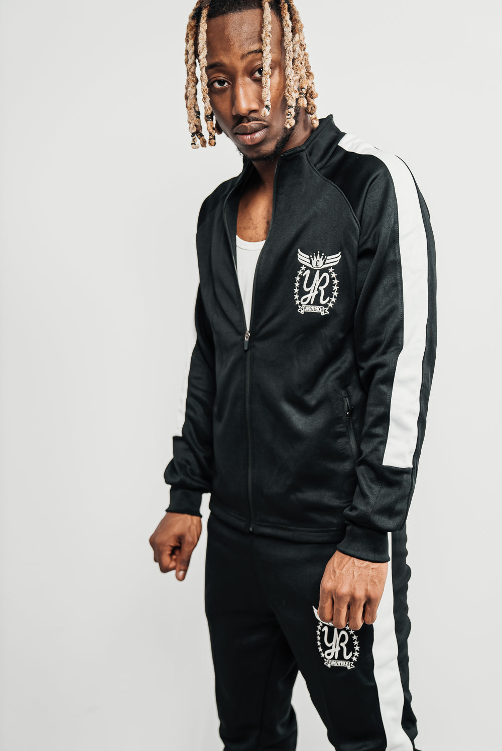"YUNG'N'RICH Men's Funnel Neck Contrast Panel Stripe Tracksuit in black and white, featuring a unique funnel neck design, bold contrast panel stripes and embroidered Yung'n'Rich branding. Perfect for everyday wear and travel, available in unisex Regular size type"
