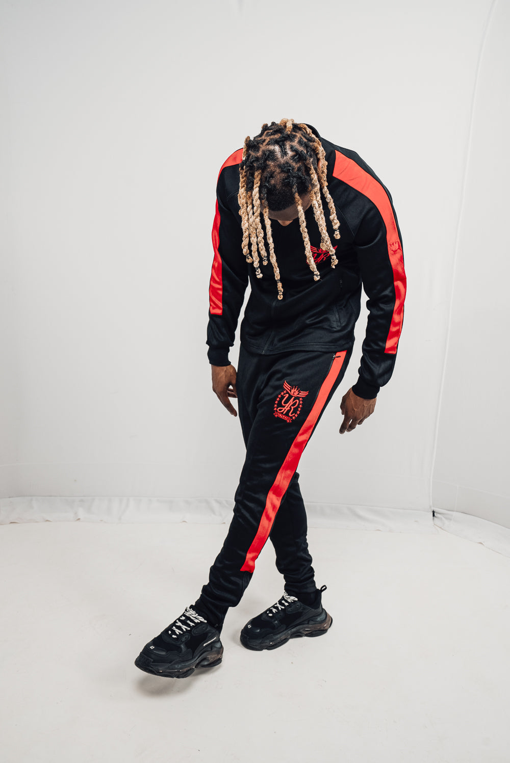 "A black and red YUNG'N'RICH Men's Funnel Neck Contrast Panel Stripe Tracksuit, featuring a fitted design with zip pockets, made with a blend of 90% polyester and 10% spandex, suitable for both men and women".