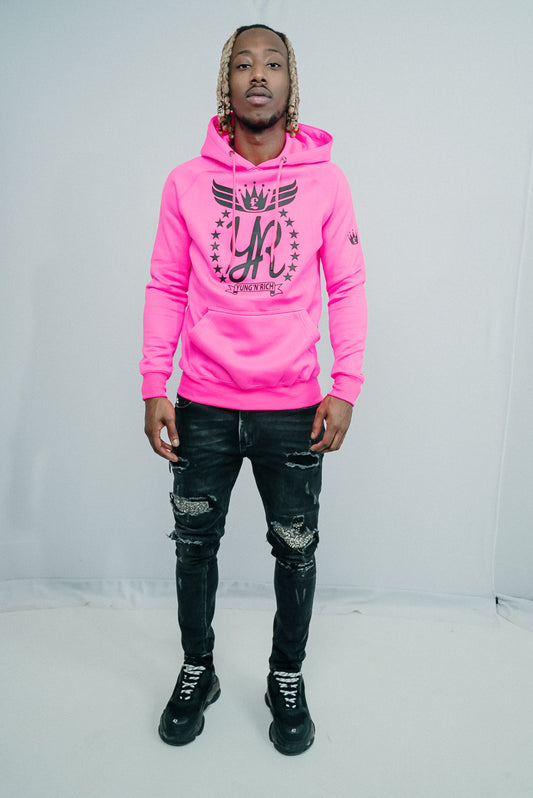 Tizzy Rapper modeling YUNG'N'RICH HOODIE - colour Neon Pink with black rubber Yungnrich logo side veiw with black rubber Yungnrich crown