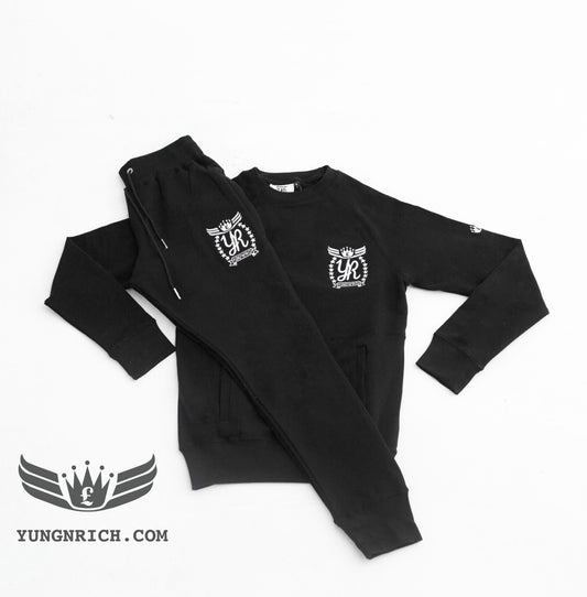 YUNG’N’RICH | CREW NECK BLACK SLIMFIT WOMENS TRACKSUIT.     Yungnrich combines sporty looks with sophisticated style successfully bringing a sense of luxury to our recreational wear. Only Available exclusively at Yungnrich, we present our sweatsuit which comes in a Black colour way. Features cotton construction, ribbed crew neck & cuffs, tonal Stay luxurious on the go in our full slim fit tracksuit . Yung’n’Rich branding on left of chest & leg.